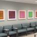 Line of chairs with line of paintings