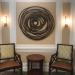 round wall art above two chairs