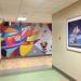 Hallway with abstract mural and hung painting