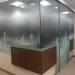 A glass walled office with a floral design that blends smoothly into a frosted glass effect