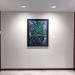 framed artwork hanging at end of hallway