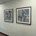 two framed artworks hang in hallway